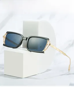 Detail view of black rectangular sunglasses with hollowed golden metal temples