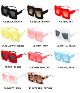 Matrix layout of oversized plush cat-eye sunglasses in multiple vibrant faux fur colors