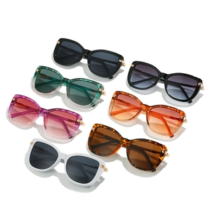 Cat eye oversized sunglasses set in multiple colors with metallic gold hinges