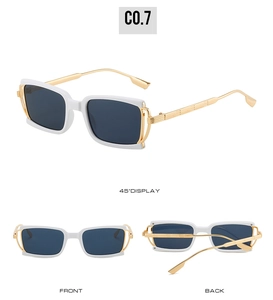 Detail view of square white sunglasses with dark blue lenses and gold metal temples