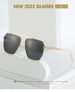 Close-up of geometric gold metal frame sunglasses with double bridge and dark lenses