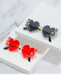 Détail de lunettes de soleil cœur sans monture avec décor de flammes et perles