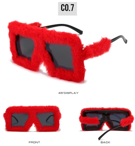 Detail view of red faux fur rectangular sunglasses with sleek black plastic temples