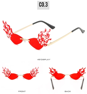 Detailed view of red flame-shaped sunglasses with pearl accents and gold metal temples