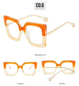 Detail view of square gradient orange frames with golden metal temples and pearl tips