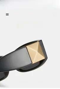 Detail of sunglasses featuring wide temples and brushed gold pyramid metal accents