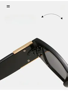 Detail of durable golden metal hinge on black rectangular sunglasses frame