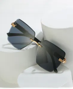 Detail view of M558 rimless sunglasses with gradient lenses and gold metal temple hinges