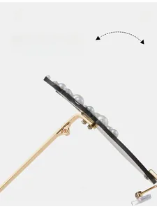 Detail of durable gold metal hinge and elegant white pearl inlay on flame sunglasses