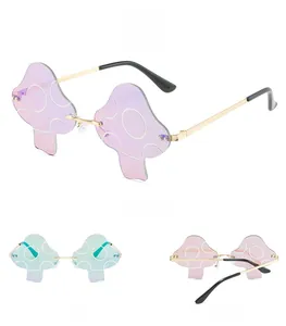Multiple views of rimless mushroom sunglasses with purple gradient lenses and gold metal arms