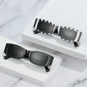 Retro rectangle sunglasses in black and stripe patterns on white geometric steps