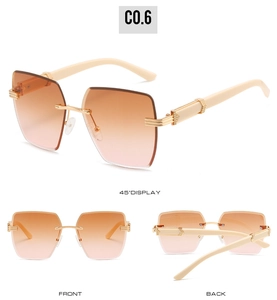 Detail view of rimless square sunglasses with gradient lenses and arrow metal accents