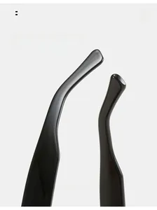 Detail of curved ergonomic sunglasses temples with polished black resin finish