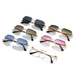 Collection of rimless sunglasses with gold metal frames and gradient lenses in multiple colors