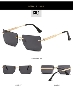 Macro detail of rimless square sunglasses featuring golden metal temples and grey lenses