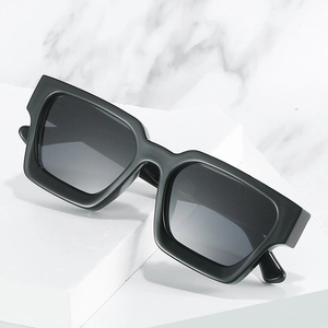 Classic black oversized square frame sunglasses with thick edges on white marble background