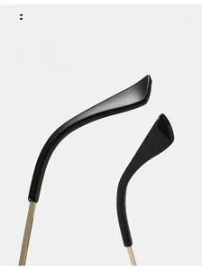 Detail of curved ergonomic temple tips and gold metal hinge on rimless sunglasses