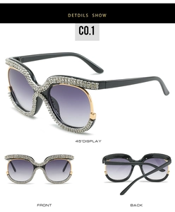 Detail view of oversized sunglasses with crystal rhinestones and purple gradient lenses