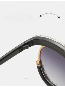 Macro detail of durable gold metal hinge and rhinestone inlay on fashion sunglasses