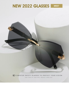 Detailed close-up of rimless geometric sunglasses with gold metal temples on a white pedestal
