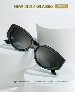 Close-up of black oval sunglasses featuring wave-patterned frames on geometric props