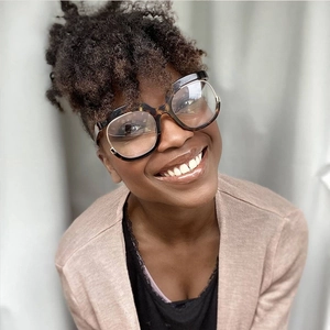 Close-up of a model wearing retro tortoise shell oversized round frame glasses