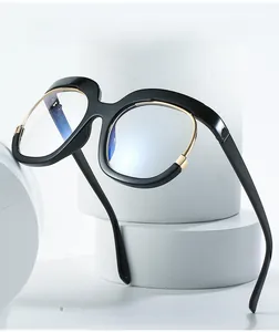 Detail of oversized black anti-blue light glasses on white geometric prop with metal trim
