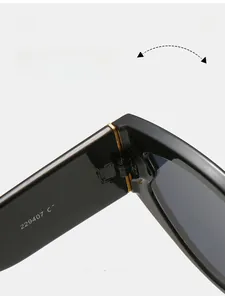 Macro detail of durable metal hinge on oval black sunglasses showing high quality texture