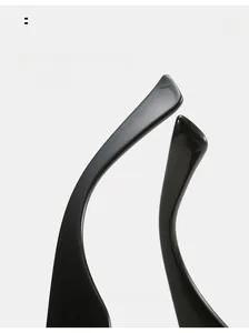 Macro detail of glossy black curved sunglasses legs with ergonomic design