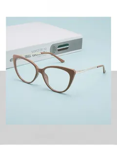 Detail of retro cat-eye glasses with brown frame and elegant pale gold metal temples