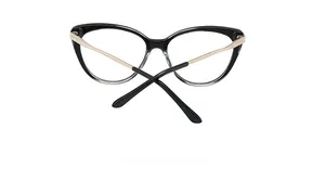 Detail view of cat eye TR90 frame with golden metal temples and sleek black gradient tips