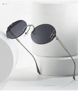 Détail de lunettes de soleil ovales sans monture avec verres gris et métal argent