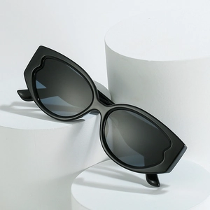 Oval sunglasses with wavy black frames displayed on white geometric display stands