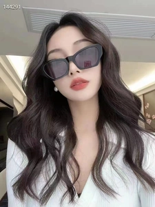 Close-up of trendy square cat-eye sunglasses with black frames on a model for a modern look