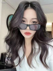 Close-up of stylish black rectangular sunglasses on model showing trendy square frame design
