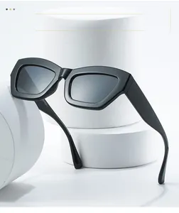 Detail of square black thick frame sunglasses resting on white cylindrical podium
