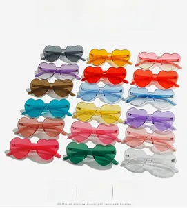 Flat lay of trendy rimless heart-shaped sunglasses in multiple vibrant candy colors