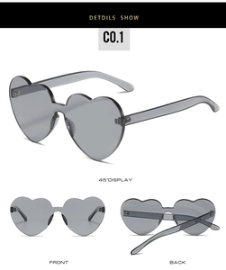 Three perspectives of rimless heart-shaped sunglasses in translucent grey lens