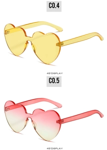 Detailed 45-degree angle view of bright yellow and pink gradient heart-shaped sunglasses