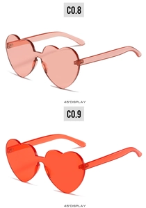 45-degree angle display of heart-shaped rimless sunglasses in pink and red shades