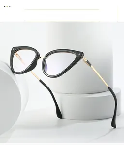 Detail of cat eye glasses frame showing black finish and gold textured metal temples
