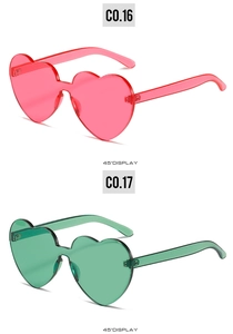 Detail view of heart-shaped rimless sunglasses in pink and green 45-degree angle