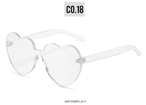 Detailed 45-degree angle view of heart-shaped rimless transparent sunglasses with a sleek design