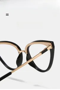 Detail showing the cat eye TR90 frame with golden metal hinges and textured temple tips
