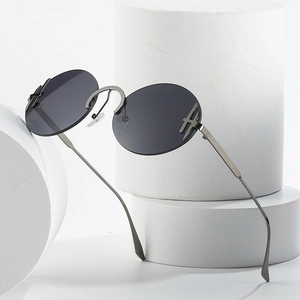 Lunettes de soleil rondes sans monture avec verres foncés et branches fines en métal