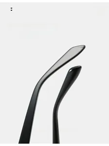 Macro detail of the glossy curved temples of black cat-eye sunglasses for ergonomic comfort