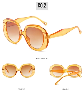 Detailed views of vintage oversized orange sunglasses with brown gradient lenses