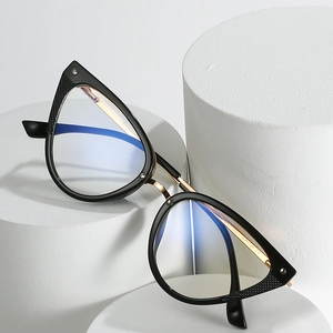 Cat eye TR90 fashion glasses with black frame and gold metal accents on white pillars