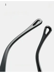 Close-up of ergonomic curved black glossy sunglasses temple with pressure relief holes