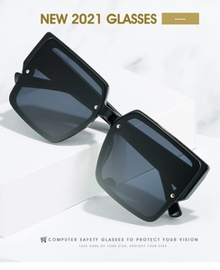 Detail of square black frame fashion glasses with silver rivets on marble background